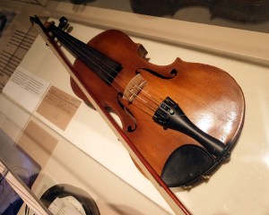 Objects which belonged to the children, such as this violin, are displayed.