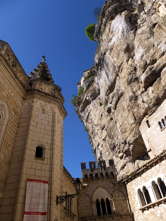 The structure seems to grow out of the rock.