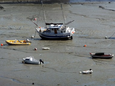 Boats of every size and description sit high and dry, stranded until the next tide comes in.