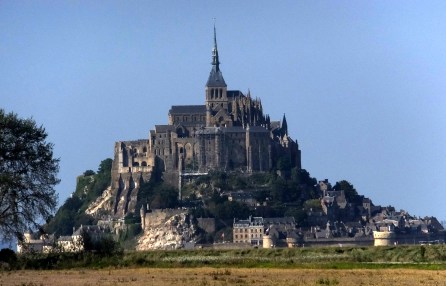 Visitors to Mont Saint-Michel see it first from miles away as a small mountain looming above a coastal plain -- some of the flattest terrain in France. This is a telephoto view from the visitors parking lot a mile-and-a-half from the island.