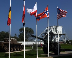 Pegasus Bridge, site of the first casualties on D-Day. It is no longer in use but has been reassembled near the original site and restored as a memorial. The British squadron that captured and held this critical bridge had landed silently in three 30-man gliders and took the Nazis by surprise. After the war the bridge was renamed "Pegasus" because that was the insignia on their uniforms. The flags of every nation that participated in the D-Day invasion are flown.