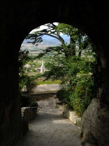 The 12th century Église Haute at the top of Bonnieux offers views such as this one through the archway leading to the churchyard. 