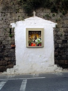 Roadside shrines also invite pedestrians to contemplate the hereafter....