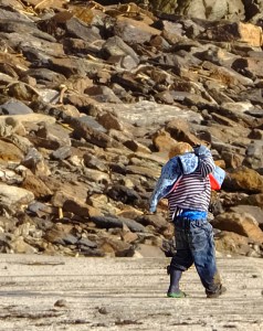 I spotted this boy playing with his family along the rocky coastline. His dirty and disheveled clothing reflects the good time he was having!