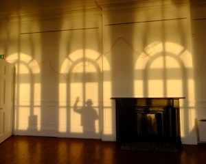 Here's my shadow visiting a minimalist modern art exhibit in the town art gallery. That sqiggly line on the wall is one of the pieces on exhibit. I found the shadows more interesting!