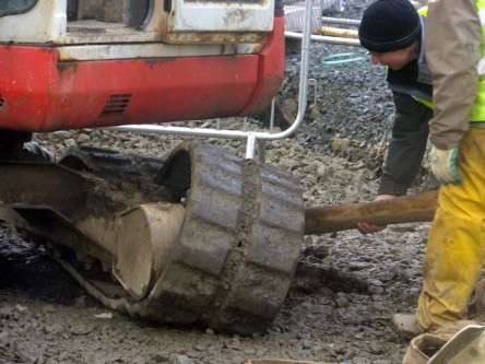 They somehow managed to get the tread back on track, moved the backhoe, and we were on our way again.