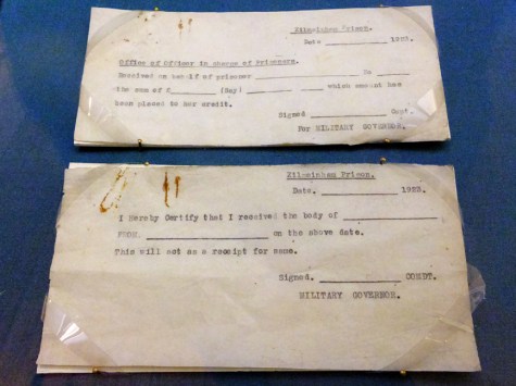 After the tour, visitors walk among exhibits containing artifacts of the prison...