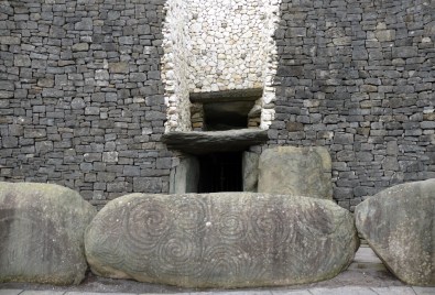 Then the guide will give you a flashlight and take you through this entrance behind the huge, spiral-etched stones. You will follow a long, narrow, irregular passage to the famous chamber deep inside, where every year, at sunrise on the winter solstice, and only on that day, a beam of light passes through the rectangular opening over the entrance, and illuminates the altar at the center of the mound.