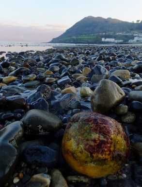 The beach itself is largely composed of colorful pebbles rounded by the sea.
